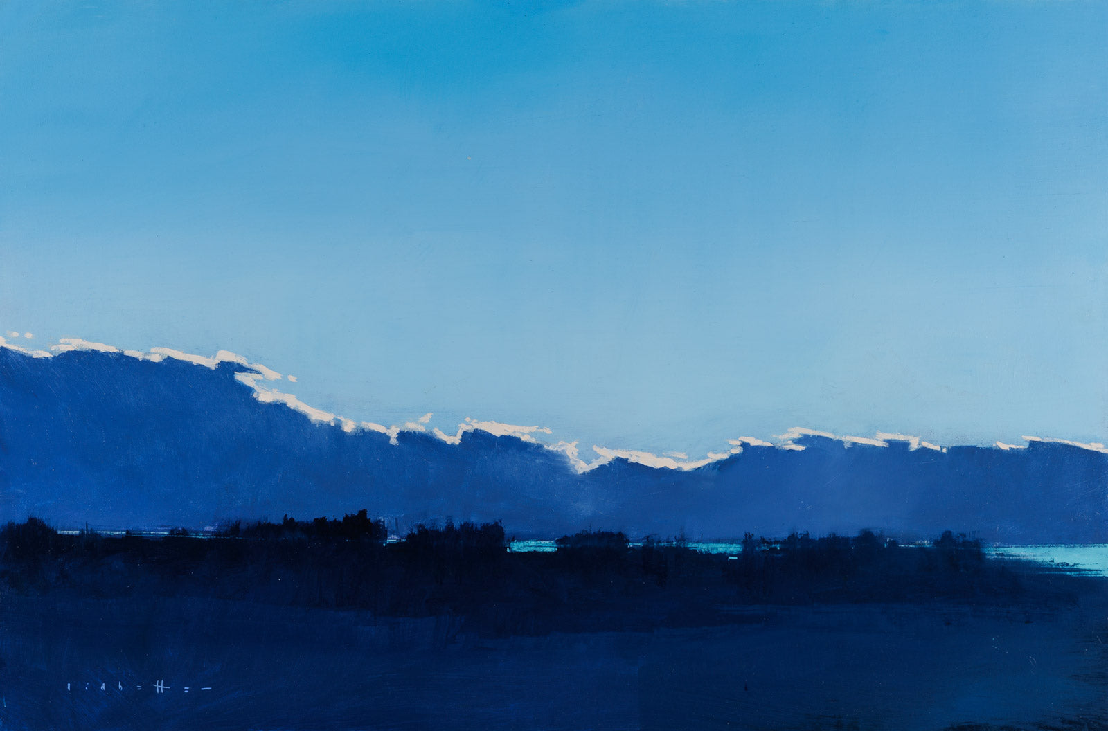 Silhouette of mountains against a blue sky with clouds